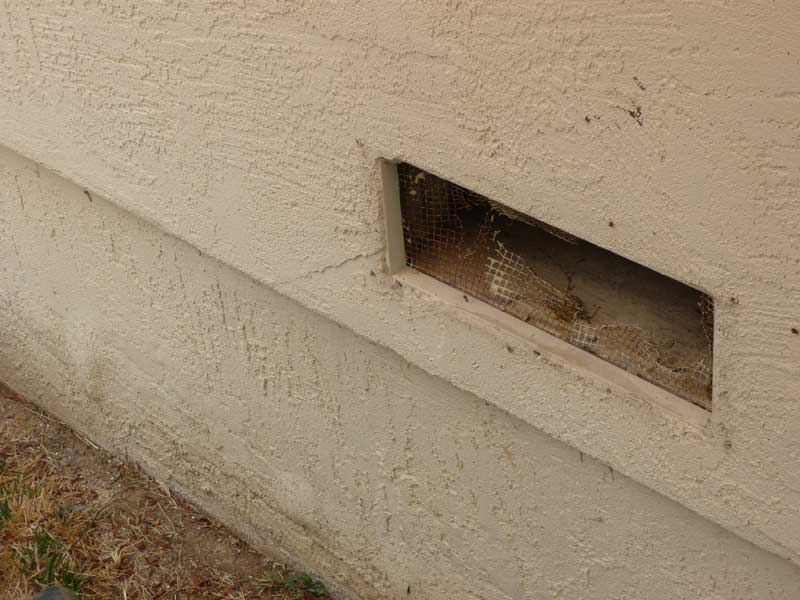Rusted out foundation and garage vent before replacement creates vector pest rat problem